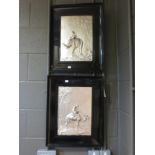 A pair of ebony framed white metal panels, one depicting a boy on a camel, the pyramids in the