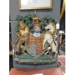 An early 20th century painted plaster Royal Warrant Coat of Arms, 46cm high