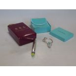 A silver key ring by Tiffany in the original case together with a silver laser pointer by Asprey &