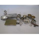 A collection of silver shell salts, peppers, pencils etc