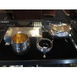 A silver tub salt with liner, a silver sugar basin, a silver table ciagrette box and an unhallmarked