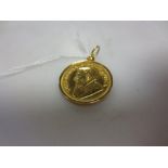 a simple pendant mount stamped '14K585' and set with a 1981 quarter Krugerrand coin 9.1g gross