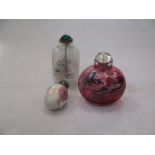 An egg shaped scent bottle, a pink glass scent bottle and a glass snuff bottle (3)