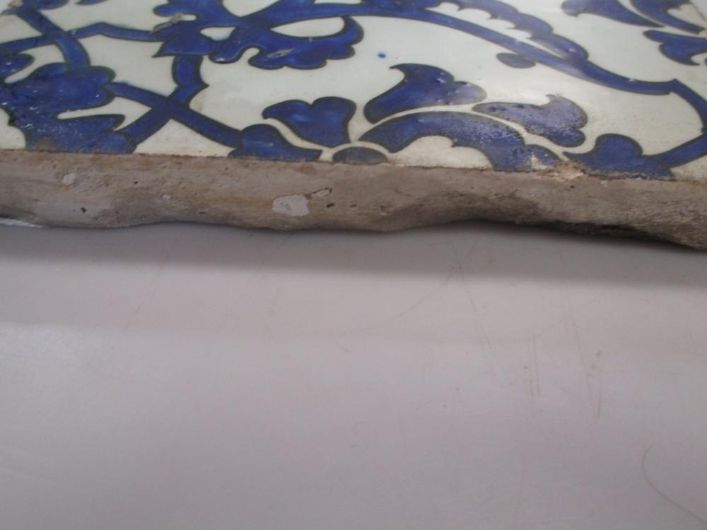 A mid 16th century Iznik 'Dome of the Rock' tile, painted in blue on the diagonal with wing shaped - Image 2 of 3