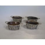 A set of four silverplated novelty salts in the form of oval wicker baskets with copper coloured