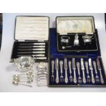 A cased three piece silver condiment set together with a silver toast rack, sauce boat, napkin ring,