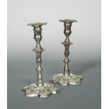 A pair of George II cast silver candlesticks, by John Cafe, London 1748, with scalloped edged bases,