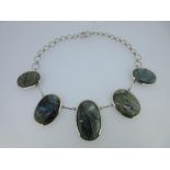 A labradorite plaque necklace, comprising five graduated oval cabochon labradorite plaques separated