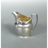 A George III silver cream jug, probably by Thomas Wallis, London 1801, of oval form, the upper