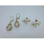 Two pairs of cultured pearl earrings both stamped for 14ct gold, the first pair with each designed
