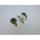 A collection of three sapphire and gemstone rings set in gold, the first a 19th century sapphire and