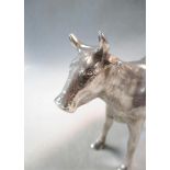 A continental metalwares naturalistic cow creamer, the detailed cast body with hinged saddle