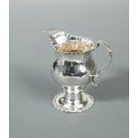 A George III silver cream jug, by Nathaniel Appleton & Ann Smith, London 1774, of baluster form with