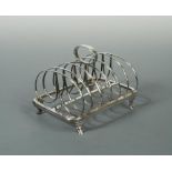 A George IV silver toast rack, by Thomas Wilkes Barker, London 1824, six bar with spectacle shaped