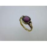 A Georgian single stone garnet ring, the mixed cushion cut purplish crimson garnet collet set to