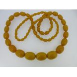 A graduated strand of butterscotch amber beads, the oval beads of slightly variable colour and