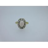 An opal and diamond cluster ring, the oval cabochon opal flying claw set to a similarly set border