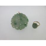 An antique Chinese jadeite jade pendant together with a jadeite ring, the pierced disc, of mottled