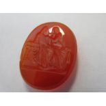 A loose intaglio carved cornelian depicting classical figures, the oval cornelian with well-detailed