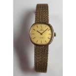 Omega - A lady's 9ct gold 'De Ville' wristwatch, circa 1978, the signed champagne coloured cushion