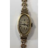 Rolex - A lady's 18ct gold wristwatch, circa 1924, the signed square dial within an oval aperture,