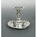 A continental metalwares candlestick, in the Spanish colonial style and of possible South American