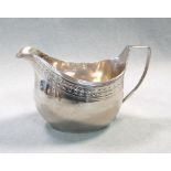 A George III silver cream jug, possibly by John Whiting, London 1806, of oval form with a band of
