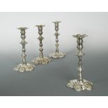 A set of four George II cast silver candlesticks, by John Priest, London 1751, with scalloped