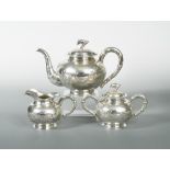 A late 19th/early 20th century Chinese export metalwares three piece tea set, makers mark CJco,