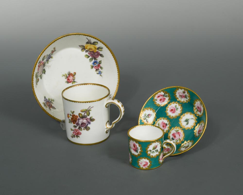 A Sevres coffee cup and saucer, painted with bouquets of flowers within gilt dentil rims, blue