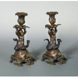 A pair of 19th century bronze candlesticks, each as a cherubic nymph riding a tortoise (2) 27cm (