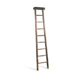 A 19th century stained pine library ladder, with a rexine cloth padded top rail 186cm (73in)