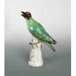 A Meissen model of a Green Woodpecker, naturalistically modelled and perched on a tree stump,