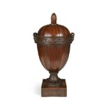 An 18th century Dutch neo-classical mahogany knife urn, carved with Bacchic masks and drapery, on