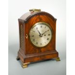 A small late George III mahogany bracket clock, circa 1800, the breakarch case with folding handle