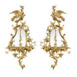 A pair of 18th century Chippendale style carved giltwood girandoles, with ho-ho bird crest and