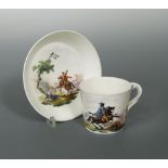 A Mennecy bucket shaped cup and saucer, circa 1765, painted with a galloping horseman, incised DV