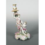 A Derby Patch Mark figural candlestick of 'Venus with Cupid', circa 1770, with foliate sconce and