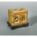 A Japanese miniature two doored, lacquer table cabinet (kodansu), Taisho/Showa Period, decorated