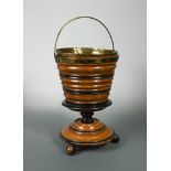 A 19th century Dutch ebonised walnut pedestal jardiniere, with brass liner, swing handle and on four