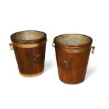 A pair of modern George III style brass bound mahogany peat buckets, each carved with a scallop