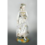 A Vion and Baury 19th century bisque porcelain figure of a young woman, in crinoline dress holding a