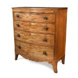 A Regency mahogany bow front chest, of four graduated long drawers, inlaid with boxwood motifs, on