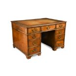 A George III mahogany pedestal partners desk, with a gilt tooled brown leather lined top, with