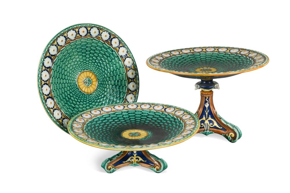 A Wedgwood Majolica dessert service, the 'basketweave' centres within stylised daisy head borders,