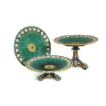 A Wedgwood Majolica dessert service, the 'basketweave' centres within stylised daisy head borders,