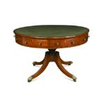 A Regency mahogany drum top library table, with green leather lined top on turned column, with