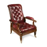 A William IV mahogany library armchair, button upholstered in a deep red leather, on gadroon moulded
