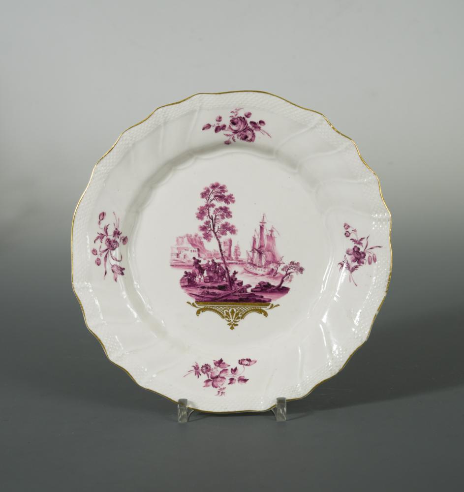 A Tournai plate, circa 1763, painted in puce by Michel-Joseph Duvivier, the central vignette with