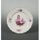A Tournai plate, circa 1763, painted in puce by Michel-Joseph Duvivier, the central vignette with